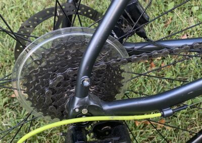 A close up of a bike with a chain and gears.